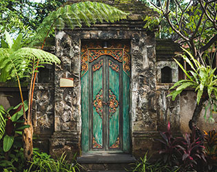 Traditional balinese handmade carved wooden door. Bali style furniture with ornament details